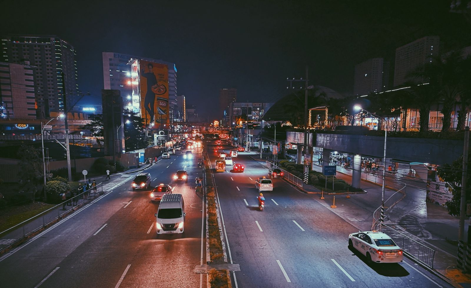 Nighttime traffic flowing through an illuminated urban transport network